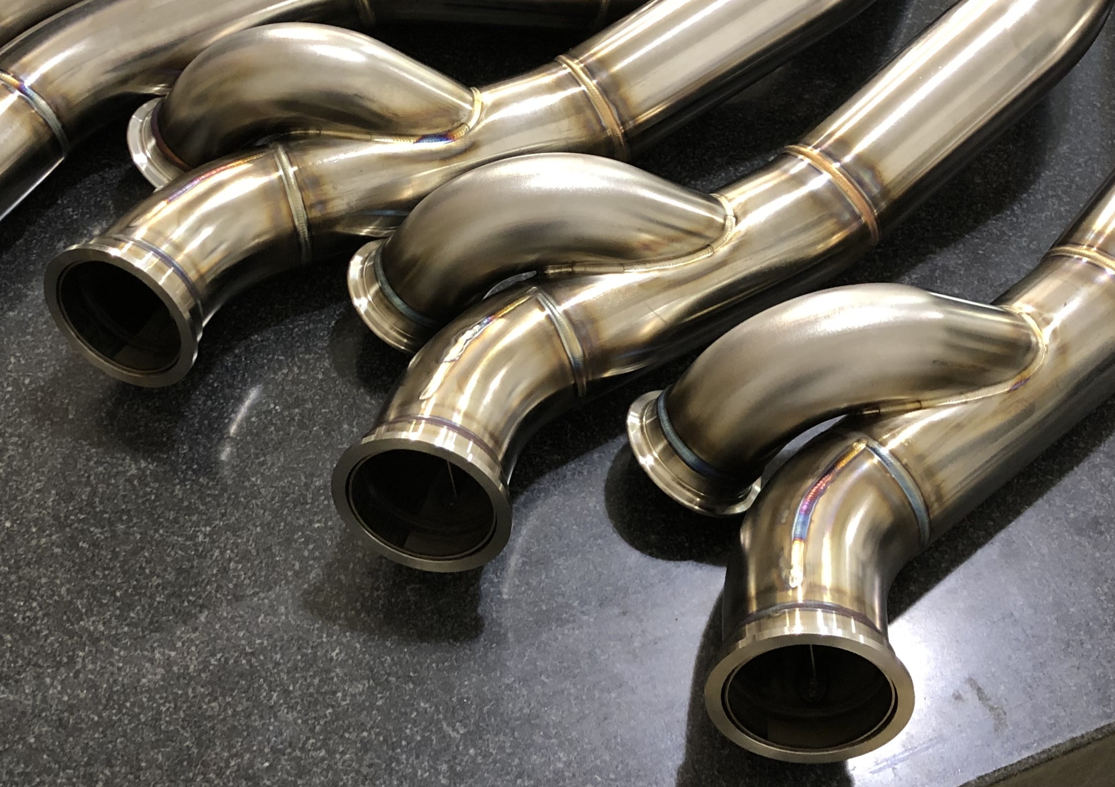 Custom stainless steel aircraft engine exhaust manifold tubes fabricated by Mace Aviation